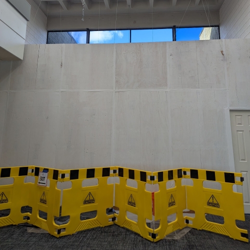 Photo: A temporary wall is erected to protect the lobby when steel beams are brought in. (11/24)