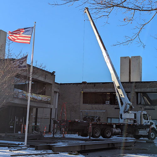 photo of truck, crane and steel beams at JCCNS entrance